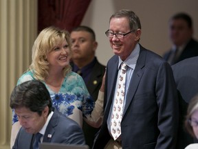State Sen. Cathleen Galgiani, D-Stockton,top  left, smiles at Sen. Tom Berryhill, R-Twain Harte, after he crossed party lines to provide the vote needed to pass AB-398, one of the two climate change bills before the legislature, Monday, July 17, 2017, in Sacramento, Calif. The Senate approved both climate change bills, backed by Gov. Jerry Brown and sent them to the Assembly for a final vote. (AP Photo/Rich Pedroncelli)