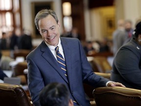 FILE - In this April 19, 2017, file photo, Texas Speaker of the House Joe Straus, R-San Antonio, talks with fellow lawmakers on the House floor at the Texas Capitol in Austin. Straus has for months opposed a "bathroom bill" targeting transgender people, saying the proposal could spark boycotts that could hurt the state's economy. The Legislature is heading into special session on Tuesday, July 25 and conservative groups have promised to target Straus and his key House lieutenants during March's GOP primaries if the issue doesn't pass. (AP Photo/Eric Gay, File)