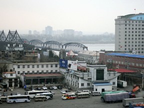 FILE - In this March 17, 2016, file photo, loaded trucks and vehicles wait in line at the border check point before crossing the Friendship Bridge linking China and North Korea across the Yalu River, as seen from Dandong in northeastern China's Liaoning Province. China's total trade with North Korea has risen in the first five months of 2017 despite Beijing's promise to enforce U.N. sanctions over its nuclear program, but Chinese purchases of North Korean goods have fallen sharply. (Chinatopix via AP, File)