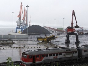 In this July 24, 2016, photo, coal from Siberia awaits loading on a ship bound for China in the North Korean special economic zone of Rason.