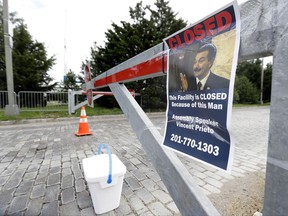 A sign hangs from a barricade at the entrance to Liberty State Park, which remains closed due to the New Jersey government shutdown, Saturday, July 1, 2017, in Jersey City., N.J. Gov. Chris Christie and the Democrat-led Legislature are set to return to work to try to resolve the state's first government shutdown since 2006 and the first under Christie. The Republican governor and the Democrat-led Legislature failed to reach an agreement on a new budget by the deadline at midnight Friday. Christie ordered nonessential services, including state parks and the motor vehicle commission to close beginning Saturday. Remaining open under the shutdown will be New Jersey Transit, state prisons, the state police, state hospitals and treatment centers as well as casinos, race tracks and the lottery. (AP Photo/Julio Cortez)