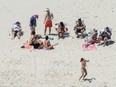 New Jersey Gov. Chris Christie, right, uses the beach with his family and friends at the governor's summer house at Island Beach State Park in New Jersey. Christie is defending his use of the beach, closed to the public during New Jersey's government shutdown, saying he had previously announced his vacation plans and the media had simply "caught a politician keeping his word."