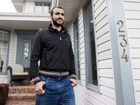 Omar Khadr walks out the front door of his lawyer Dennis Edney's home to speak the media in Edmonton, Alberta on Thursday, May 7, 2015.