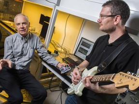 Rick McCreery, left, University of Alberta chemistry professor and senior researcher at the National Institute for Nanotechnology (NINT) and Adam Bergen, a former post-doctoral fellow and now research officer at NINT speak at a lab in Edmonton on October 7, 2016 in this handout photo. For years, serious guitar players have clung to their tube amplifiers, saying the rich sound is worth the hassle of old-school electronics. Now, scientists at the University of Alberta have used the latest nanotechnology in a guitar pedal that duplicates that beloved warmth without the inconvenience and expense. THE CANADIAN PRESS/HO, University of Alberta, John Ulan *MANDATORY CREDIT*