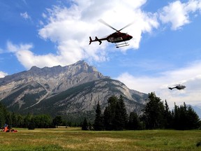 Helicopters are seen leaving a fire base for the Verdant Creek wildfire in an undated Parks Canada handout image.