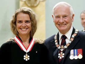 Canadian astronaut Julie Payette stands with Governor General David Johnston after she was invested into the Order of Canada as Officer during a ceremony at Rideau Hall in Ottawa, on Sept., 16 2011 .