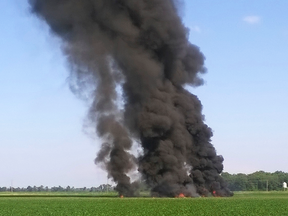 Smoke and flames rise after a military transport airplane crashed in a field near Itta Bena, Miss., Monday, July 10, 2017