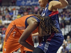 Connecticut Sun's Jonquel Jones, left, is fouled by Washington Mystics' Krystal Thomas in the first half of a WNBA basketball game Saturday, July 8, 2017, in Uncasville, Conn. (Sean D. Elliot/The Day via AP)