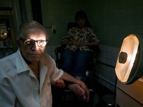 In this June. 8, 2017 photo, podiatrist Serafin Barca poses for a photo with a patient in his clinic in Havana, Cuba. The 80-year-old podiatrist is one of the last private medical workers in communist Cuba, which prides itself on its free, universal state health care. (AP Photo/Ramon Espinosa)