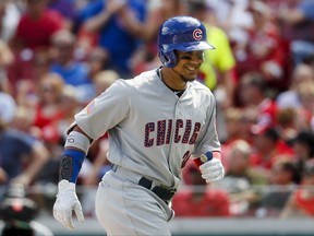 Chicago Cubs' Jon Jay smiles as he runs toward the dugout after hitting a solo home run off Cincinnati Reds starting pitcher Jackson Stephens in the third inning of a baseball game, Saturday, July 1, 2017, in Cincinnati. (AP Photo/John Minchillo)