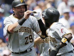 Pittsburgh Pirates' Francisco Cervelli, left, celebrates with Josh Harrison after hitting a grand slam during the first inning of a baseball game against the Chicago Cubs, Sunday, July 9, 2017, in Chicago. (AP Photo/Nam Y. Huh)