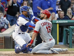 Chicago Cubs' Willson Contreras, left, tags out St. Louis Cardinals' Matt Carpenter, right, during the first inning of a baseball game, Sunday, July 23, 2017, in Chicago. (AP Photo/Kamil Krzaczynski)