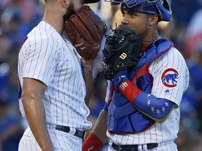 Chicago Cubs starting pitcher Jake Arrieta, left, talks with catcher Willson Contreras during the second inning of a baseball game against the Pittsburgh Pirates, Saturday, July 8, 2017, in Chicago. (AP Photo/Nam Y. Huh)