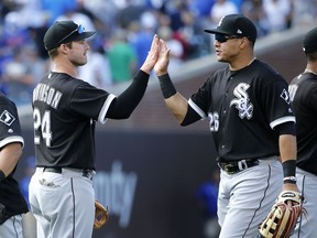 Chicago White Sox's Matt Davidson (24) and Avisail Garcia celebrate their win over the Chicago Cubs after a baseball game Monday, July 24, 2017, in Chicago. (AP Photo/Charles Rex Arbogast)