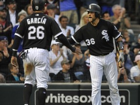 Chicago White Sox's Kevan Smith (36) celebrates with teammate Avisail Garcia (26) after Garcia scored on a Tyler Saladino ground rule double during the second inning of a baseball game against the Seattle Mariners Friday, July 14, 2017, in Chicago. (AP Photo/Paul Beaty)