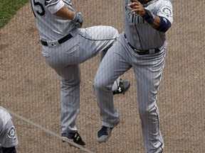 Seattle Mariners' Kyle Seager, left, celebrates with Robinson Cano after hitting a solo home run against the Chicago White Sox during the fourth inning of a baseball game, Sunday, July 16, 2017, in Chicago. (AP Photo/Nam Y. Huh)