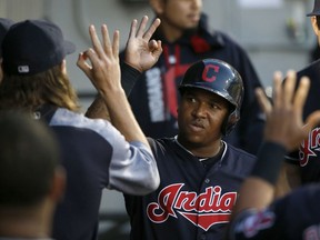 Cleveland Indians' Jose Ramirez celebrates in the dugout after scoring on a single by Yan Gomes during the fourth inning of a baseball game against the Chicago White Sox on Friday, July 28, 2017, in Chicago. (AP Photo/Charles Rex Arbogast)