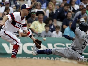 Seattle Mariners' Guillermo Heredia, right, is safe at third as Chicago White Sox third baseman Todd Frazier tries to catch the ball during the sixth inning of a baseball game Sunday, July 16, 2017, in Chicago. Heredia advanced to third on a throwing error by White Sox center fielder Alan Hanson. (AP Photo/Nam Y. Huh)