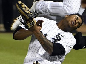 Chicago White Sox second baseman Yoan Moncada, top, and Chicago White Sox right fielder Willy Garcia, bottom, collide on a double hit by Toronto Blue Jays' Darwin Barney during the sixth inning of a baseball game, Monday, July 31, 2017, in Chicago. Both players had to leave the game. (AP Photo/David Banks)