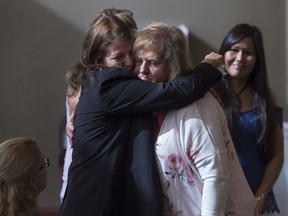 Taylor Samson's mother, Linda Boutilier, centre, hugs family and friends before victim impact statements are read in the murder trial of William Sandeson at Nova Scotia Supreme Court in Halifax on Tuesday, July 11, 2017. Sandeson was found guilty of first-degree murder in the death of Samson, a fellow Dalhousie University student, who was last seen on Aug. 15, 2015 and whose body has not been found. THE CANADIAN PRESS/Darren Calabrese