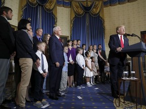 Vice President Mike Pence and others listen as President Donald Trump speaks during an event about healthcare, Monday, July 24, 2017, in the Blue Room of the White House in Washington. (AP Photo/Alex Brandon)