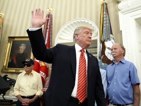 President Donald Trump waves as he departs after a meeting with survivors of the attack on USS Arizona at Pearl Harbor, in the Oval Office of the White House, Friday, July 21, 2017, in Washington. (AP Photo/Alex Brandon)