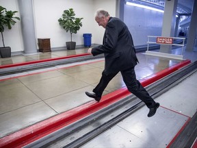 Sen. Jerry Moran, R-Kan. jumps the tracks of the Senate subway on Capitol Hill in Washington, Tuesday, July 18, 2017, to get around a large gathering of reporters as he arrives on Capitol Hill. (AP Photo/Andrew Harnik)