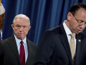 Deputy Attorney General Rod Rosenstein, right, accompanied by Attorney General Jeff Sessions, left, speaks at a news conference to announce an international cybercrime enforcement action at the Department of Justice, Thursday, July 20, 2017, in Washington. (AP Photo/Andrew Harnik)