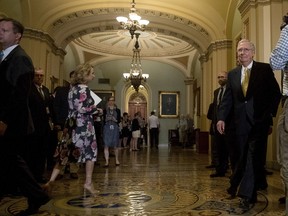 Senate Majority Leader Mitch McConnell of Ky., right, arrives for a news conference on Capitol Hill in Washington, Tuesday, July 18, 2017. President Donald Trump blasted congressional Democrats and "a few Republicans" over the collapse of the GOP effort to rewrite the Obama health care law. McConnell proposed a vote on a backup plan simply repealing the statute, but that idea was on the brink of rejection, too. (AP Photo/Andrew Harnik)