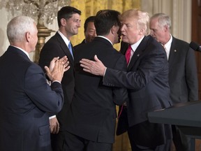 President Donald Trump, embraces Wisconsin Gov. Scott Walker, as Vice President Mike Pence, House Speaker Paul Ryan of Wis., Terry Gou, president and chief executive officer of Foxconn, and Sen. Ron Johnson, R-Wis., also stand on stage in the East Room of the White House in Washington, Wednesday, July 26, 2017. (AP Photo/Carolyn Kaster)
