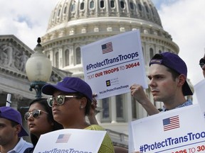 Steven McCarty, right, and others, attends an event in support of transgender members of the military, Wednesday, July 26, 2017, on Capitol Hill in Washington, after President Donald Trump said he wants transgender people barred from serving in the U.S. military "in any capacity," citing "tremendous medical costs and disruption." (AP Photo/Jacquelyn Martin)