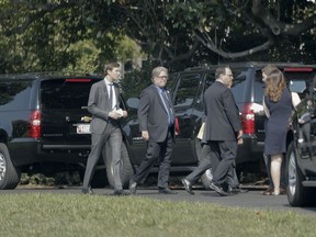 White House Senior Adviser Jared Kushner, left, and White House chief strategist Steve Bannon, center, walk to their vehicle on the South Lawn of the White House in Washington, Thursday,July 20, 2017, to join the motorcade with President Donald Trump for a visit to nearby Pentagon. (AP Photo/Pablo Martinez Monsivais)