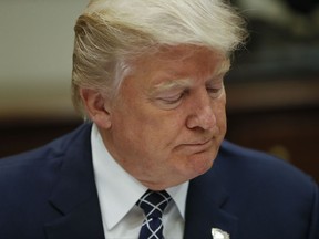 President Donald Trump pauses while having lunch with services members in the Roosevelt Room of the White House in Washington, Tuesday, July 18, 2017. (AP Photo/Pablo Martinez Monsivais)