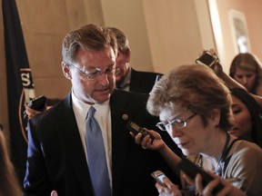 Sen. Dean Heller, R-Nev. speaks to members of the media while walking in the hallways on Capitol Hill in Washington Thursday, July 13, 2017. Senate Majority Leader Mitch McConnell of Ky. plans to roll out the GOP's revised health care bill, pushing toward a showdown vote next week with opposition within the Republican ranks. (AP Photo/Pablo Martinez Monsivais)