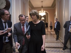 Sen. Lisa Murkowski, R-Alaska is approached by reporters as she enters the Senate chamber on Capitol Hill in Washington, Thursday, July 27, 2017, as the Republican majority in Congress remains stymied by their inability to fulfill their political promise to repeal and replace "Obamacare" because of opposition and wavering within the GOP ranks. (AP Photo/J. Scott Applewhite)