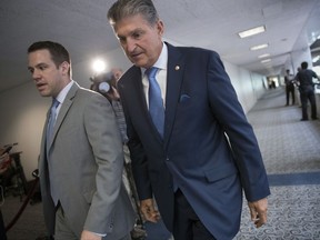 Sen. Joe Manchin, D-W.Va., center, a member of the Senate Intelligence Committee, leaves after a closed-door meeting of that panel on Capitol Hill in Washington, Thursday, July 20, 2017. The Senate intelligence committee has scheduled perhaps the most high-profile testimony involving the Russian meddling probes since former FBI Director James Comey appeared in June. A lawyer for Trump's powerful son-in-law and adviser says Jared Kushner will speak to the Senate intelligence committee Monday. Donald Trump Jr. is scheduled to appear before the Senate Judiciary Committee next Wednesday along with former campaign chairman Paul Manafort. (AP Photo/J. Scott Applewhite)