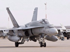 A pilot positions a CF-18 Hornet at the CFB Cold Lake, in Cold Lake, Alberta on Tuesday, October 21, 2014. Royal Canadian Air Force commander Lt.-Gen. Mike Hood is pushing back against critics who say the Liberal government is taking too long to launch a competition for new fighter jets. THE CANADIAN PRESS/Jason Franson