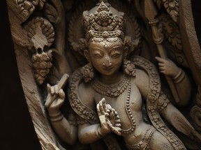 This photo taken Wednesday, July 19, 2017, shows a detail of a wooden crafted window partially damaged during Nepal's 2015 earthquake. A team of dedicated woodworkers is now trying to restore Nepal's heritage. They have been working six days a week, for nearly two years, repairing the beautifully hand-carved wooden doors and windows. (AP Photo/Niranjan Shrestha)