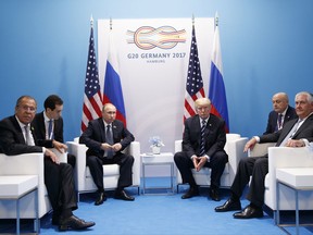 President Donald Trump meets with Russian President Vladimir Putin at the G20 Summit, Friday, July 7, 2017, in Hamburg. Russian Foreign Minister Sergey Lavrov is at left, Secretary of State Rex Tillerson is at right. (AP Photo/Evan Vucci)