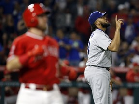 Los Angeles Dodgers relief pitcher Kenley Jansen, right, points to the sky after striking out Los Angeles Angels' Cliff Pennington, right, during the ninth inning of a baseball game in Anaheim, Calif., Thursday, June 29, 2017. The Dodgers won 6-2. (AP Photo/Alex Gallardo)