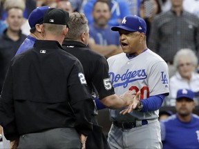 Los Angeles Dodgers manager Dave Roberts, right, speaks to home plate umpire Greg Gibson after an argument during the second inning of the team's baseball game against the San Diego Padres on Friday, June 30, 2017, in San Diego. (AP Photo/Gregory Bull)