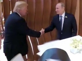 In this image taken from video U.S. President Donald Trump, left, shakes hand with the Russian President Vladimir Putin during the G20 summit in Hamburg Germany, Friday July 7, 2017.
