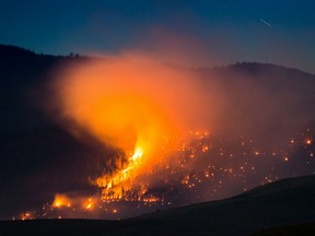 A wildfire burns on a mountain near Ashcroft, B.C., late Friday July 7, 2017. More than 3,000 residents have been evacuated from their homes in central British Columbia. A provincial state of emergency was declared after 56 new wildfires started Friday