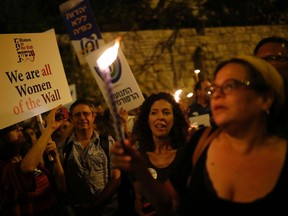 Israeli protesters gather outside Prime Minister Benjamin Netanyahu's residence in Jerusalem on July 1, 2017, to demonstrate against a government decision to abandon a deal to allow women and men to pray together at the Western Wall.