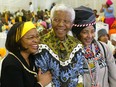 Former South African President Nelson Mandela celebrates his 86th birthday with his wife Graca Machel ( L ) and ex -wife Winnie Madikizela Mandela ( R ) in his rural home town of Qunu in the Eastern Cape Province 18 July 2004.