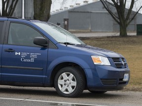 A Canada Food Inspection Agency vehicle sits outside of a turkey farm on Highway 2/