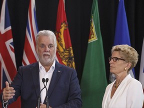 Quebec Premier Philippe Couillard and Ontario Premier Kathleen Wynne speak during a press conference during the Council of Federation meetings in Edmonton Alta, on Tuesday July 18, 2017. THE CANADIAN PRESS/Jason Franson