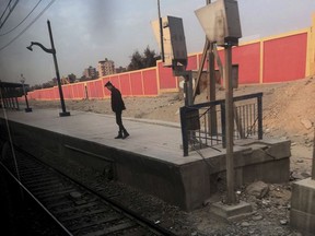 In this Feb. 1, 2017 photo, an Egyptian security stands guard at a metro station, in Cairo, Egypt. At a time when security forces are in a years-long fight with Islamic militants, metal detectors have been set up at entrances of all stations, though commuters are rarely searched when the device beeps. Sniffer dogs and policemen, some wearing body armor, patrol stations. Posters of wanted militants are plastered next to ticket booths. (AP Photo/Nariman El-Mofty)