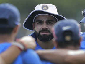 CORRECTS TEAM NAME: India's cricket captain Virat Kohli, center, speaks to his team members before the start of a warm up game with Sri Lanka's Board XI in Colombo, Sri Lanka, Friday, July 21, 2017. (AP Photo/Eranga Jayawardena)