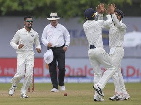 India's bowler Raveendra Jadeja, left, captain Virat Kohli, right, and Abhinav Mukund celebrate the dismissal of Sri Lanka's Angelo Mathews during the third day's play of the first test cricket match between India and Sri Lanka in Galle, Sri Lanka, Friday, July 28, 2017. (AP Photo/Eranga Jayawardena)